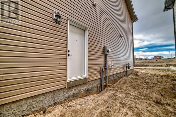 Photo 2 - Backyard - 45 Shale Avenue, Cochrane, AB T4C3G6